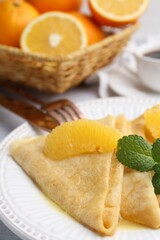 Delicious Crepes Suzette served on light table, closeup
