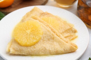 Delicious Crepes Suzette on white table, closeup