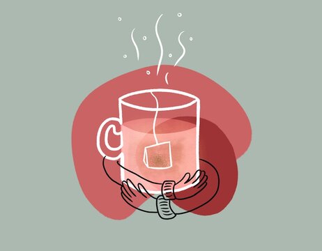 Hands hugging a cup of tea