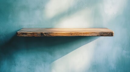 A single rustic wooden shelf mounted in a minimalist room with soft, muted tones.