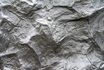 Textured plaster surface displays intricate patterns that mimic natural formations