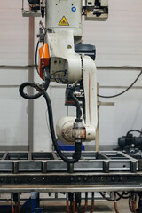 Industrial robot for welding metal parts