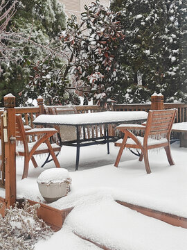 Frozen garden and outdoor furniture at winter storm.