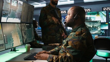 Military dispatcher relays info from army intelligence analysts to troops on front lines, close up...