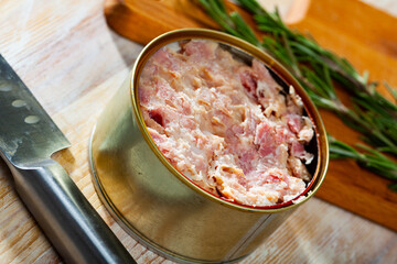 Can of preserved stewed meat on wooden background