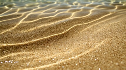 Sunlight illuminating wavy sand underwater.