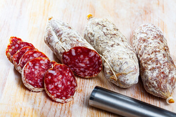 Sliced italian dry sausage salamini on wooden cutting board