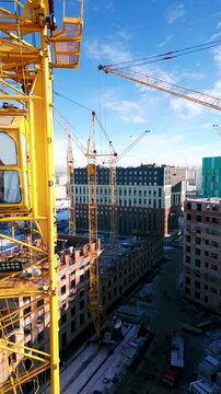 Drone flies close to tower crane operator at construction site