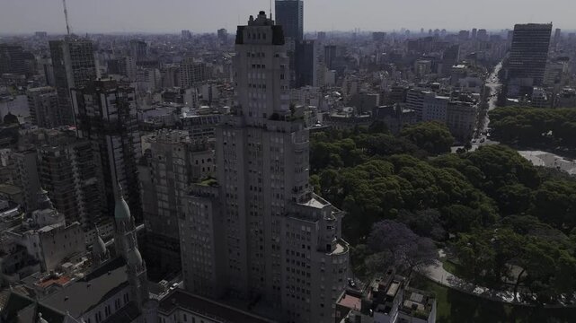 Drone orbits around left side of Edificio Kavanagh in the afternoon in Buenos Aires, Argentina