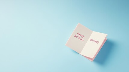 Pink Happy Birthday card on blue background.