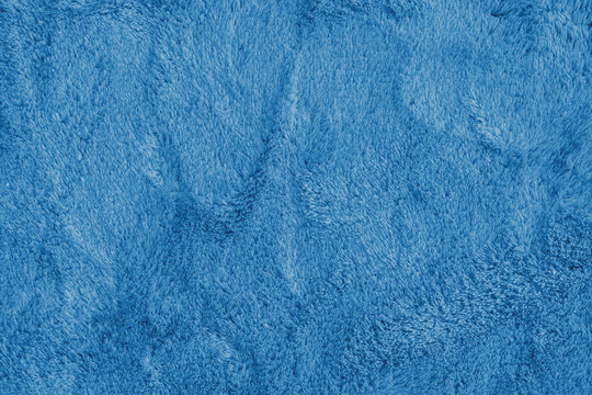 Soft shaggy blue carpet texture. Fluffy synthetic textile fur, plush textile, blanket cloth background. Wallpaper, backdrop, solid color - Powered by Adobe