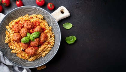 fusilli pasta with meatballs in tomato sauce and basil in a bowl italian cuisine top view flat lay with copy space image place for adding text or design