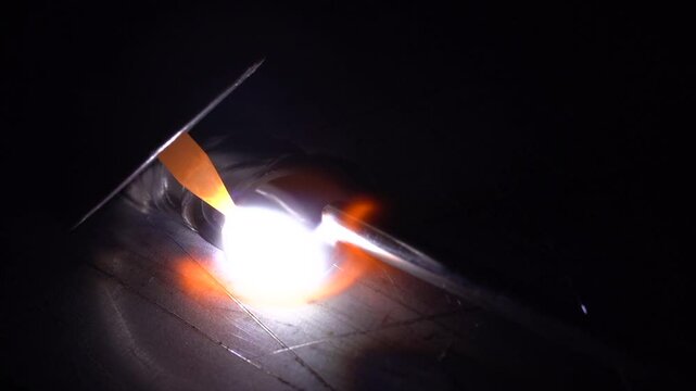 The process of welding stainless steel and metal using the TIG method close-up macro, macro shot of metal melting from TIG welding