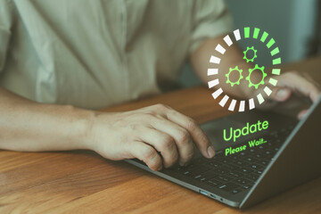 Man working and installing update process on a laptop while a glowing update progress graphic with...