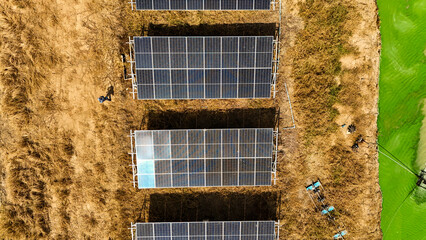 Renewable energy farm with solar panels and water ponds, highlighting sustainable development,...