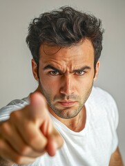 Fototapeta premiumHandsome Man Showing Frustration with Angry Expression Holding Tie on White Background