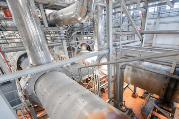 Overview of a chemical plant with extensive pipelines and conveyor systems working for industrial...