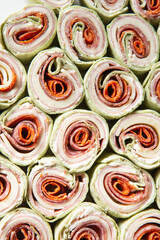 Italian Sub Pinwheels with pepperoni, salami, ham, provolone, mozzarella, cheese wraps for party appetizers