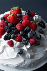 Mixed Berry Pavlova, tall marshmellow meringue topped with straberries, blueberries, blackberries and raspberries