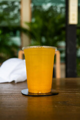 One glass of passion fruit serve on table in green garden