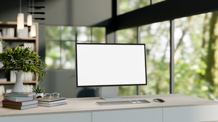 A computer desk in a modern office or home office featuring a computer and decor on a wooden table.