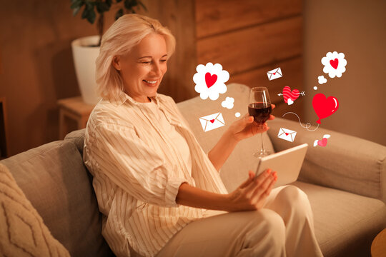Mature woman with wine and tablet computer having online date at home in evening