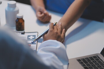 Doctor giving hope. Close up shot of young female physician leaning forward to smiling elderly lady patient holding her hand in palms. Woman caretaker in white coat supporting encouraging old person