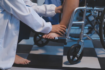 Obraz premium Asian young professional successful friendly female nurse in blue hospital uniform helping supporting physical therapy senior old pensioner unhealthy injury woman patient walking via four legs walker.