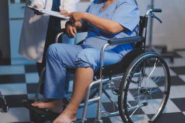 Obraz premium Asian young professional successful friendly female nurse in blue hospital uniform helping supporting physical therapy senior old pensioner unhealthy injury woman patient walking via four legs walker.