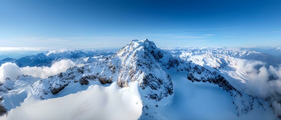 Obraz premium Majestic Snow-Covered Mountain Range Under Clear Blue Sky with Scenic Cloud Formation