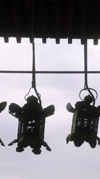 Traditional japanese lanterns hanging from temple roof