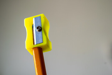 Pencil and SharpeneA close-up of a pencil and sharpener in sharp focus against a blurred background, highlighting simplicity and precision. This minimalist image is ideal for projects related to