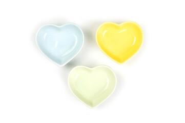 Top view, Colorful (blue, yellow, green) heart-shaped bowls isolated on a white background. Template for food design, and banner. Use for home or restaurant...