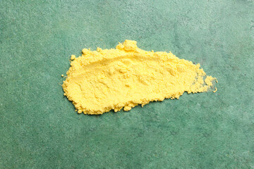 Yellow powder pigment on green background