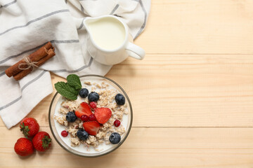 Composition with tasty oatmeal and berries on wooden background