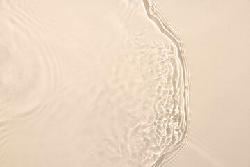 Texture of clean water with ripples on beige background