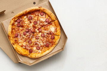 Cardboard boxes with tasty pizza on white background