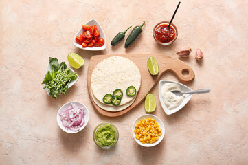 Cutting board with ingredients for tasty taco on beige grunge background