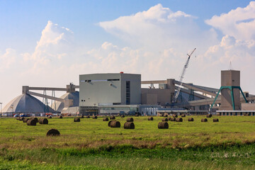 A large industrial plant with a lot of machinery and a large crane