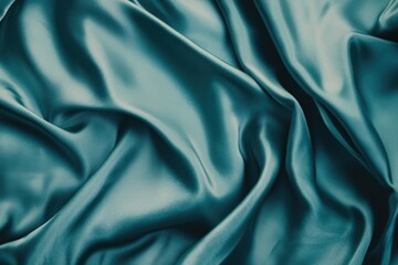 Obraz premium Teal silk fabric with elegant folds and drapes.