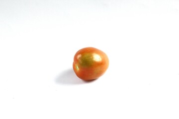 A tomato on a white background. Tomatoes, or Solanum lycopersicum, are a seasonal fruit of the Solanaceae family native to Central and South America. It has a sour and slightly sweet flavor.