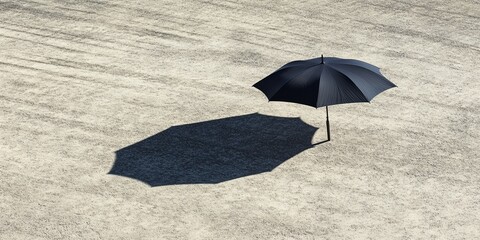 A lone black umbrella stands on a sandy surface, casting a distinct shadow in a minimalist outdoor scene.