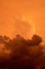 The Rayleigh scattering phenomenon - orange clouds and sky image in vertical format for background use