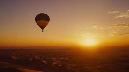 Obraz premium Sunrise Hot Air Balloon Ride over Desert Dunes
