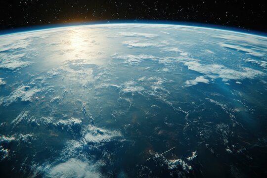 Earth viewed from space at dawn with sunlight illuminating the horizon and clouds forming an intricate pattern