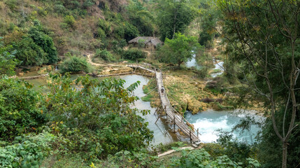 The old wooden bridge in a rural Vietnamese town. Colorful of life in countryside concept.