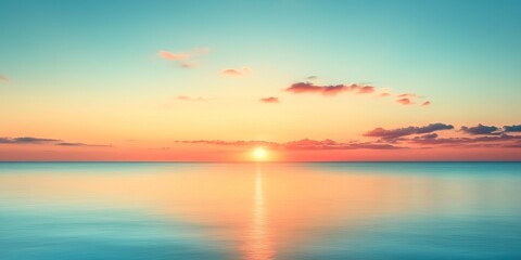 Obraz premium Experience tranquility in this stunning sunset over the calm ocean. The soft colors blend seamlessly, creating a peaceful scene perfect for relaxation or inspiration.