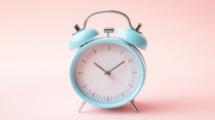 Pastel blue alarm clock on pink background.