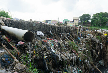 factory waste and household waste pollute the river