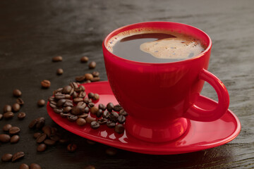 Cup of coffee on a saucer on a black background for breakfast